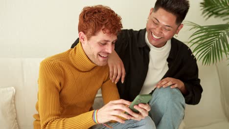 happy couple sharing a smartphone moment at home
