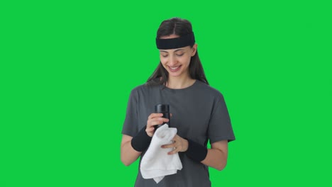 Happy-Indian-girl-wiping-sweat-and-drinking-water-after-workout-Green-screen