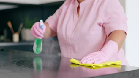 woman, cloth and spray for cleaning of kitchen to