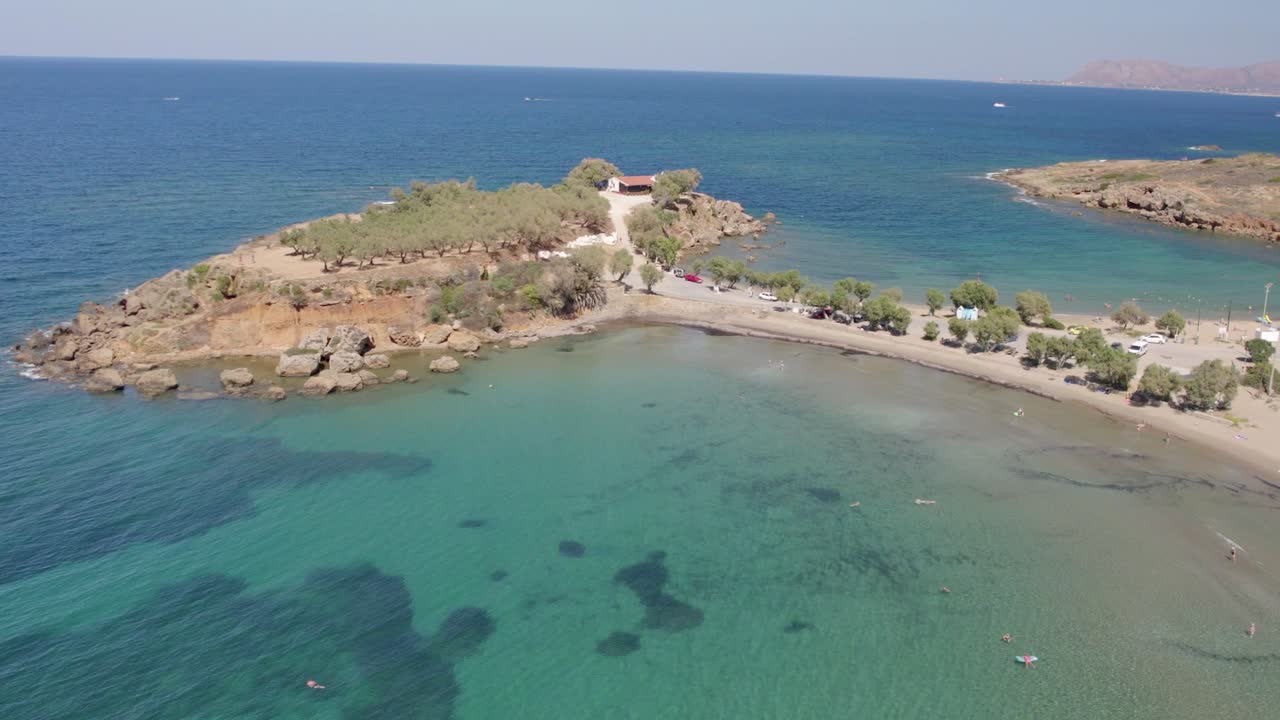 vista aérea del océano azul con agua clara en verano con la playa agii apostoli y la capilla de los santos apóstoles en nea kydonia, chania, grecia
