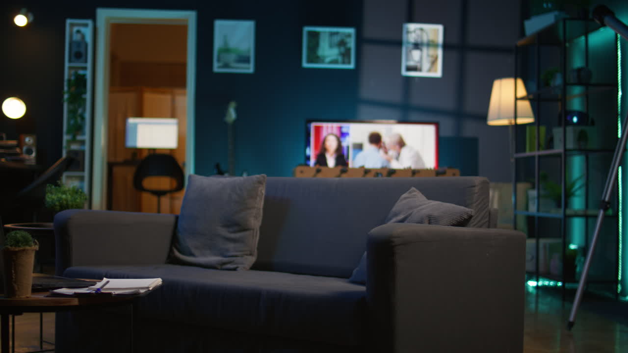 Empty stylish studio apartment with cool trendy decorations and equipment for a young man, minimalist space decorated with led neon lights. Cozy urban loft with a home theatre setup.