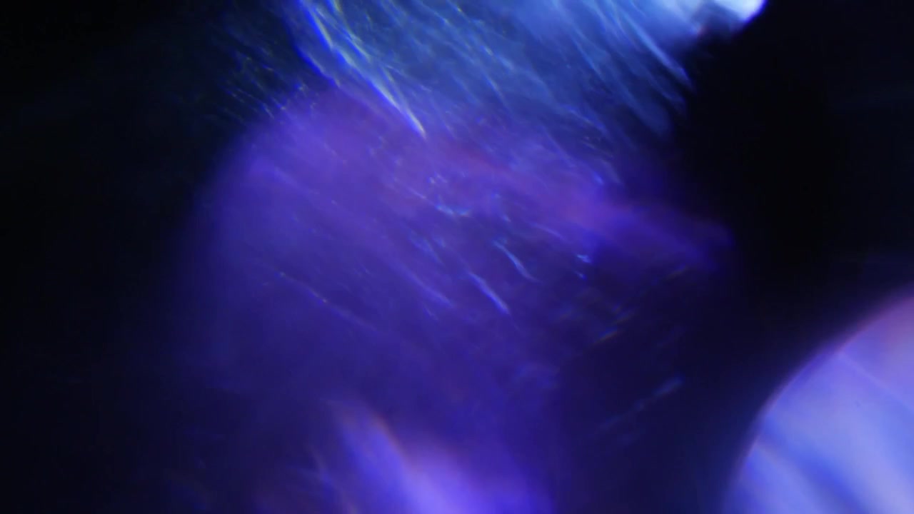Dynamic Blue and Purple Light Leaks on Black Background