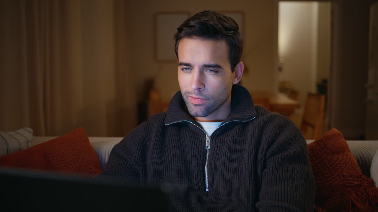Late worker pondering idea using laptop on couch closeup. Freelancer thinking