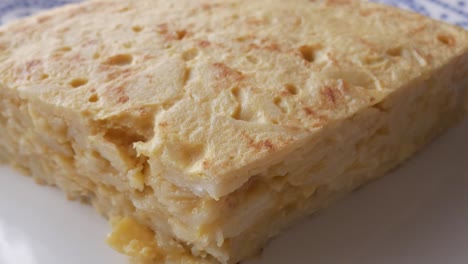 spanish potato omelette with golden edges, sliced to reveal soft, fluffy interior