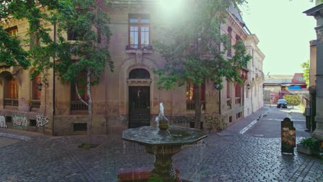 Orbit-in-Liberty-of-the-Press-square-and-eclectic-architecture-with-sunlight-filtering-through-the-roof-Concha-y-Toro-neighborhood,-Santiago-Chile