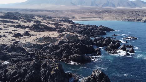 aerial: rugged rocky ocean coast of desert mountain landscape in chile