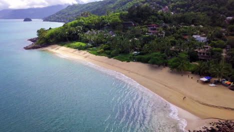 Rotating-air-record-during-dawn-on-a-beach-with-crystal-clear-waters