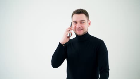 smiling man walks and talk the phone on white background. handsome businessman giving instructions through the mobile phone conversation.