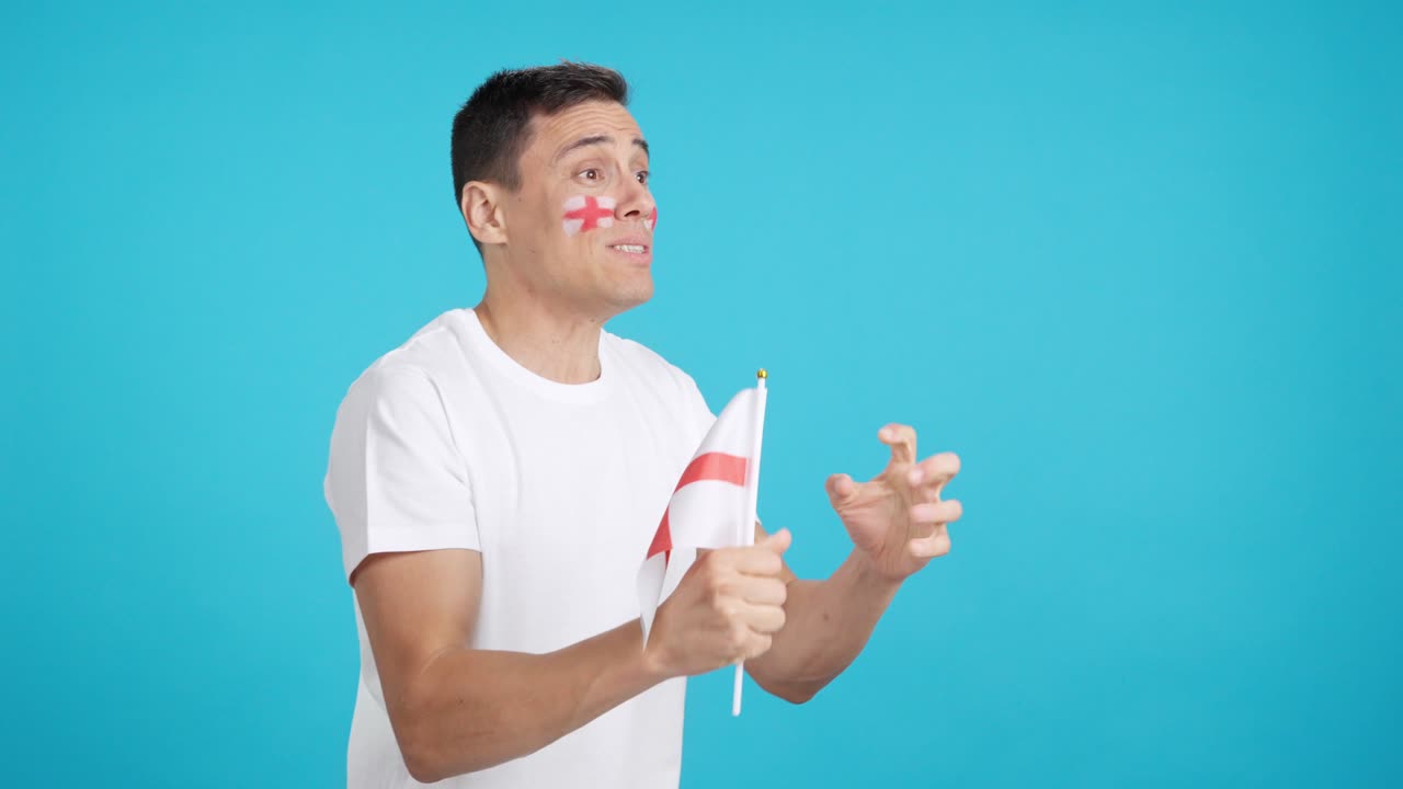 Nervous english supporter during an exciting match looking away