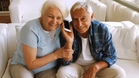 Senior-couple-talking-on-mobile-phone