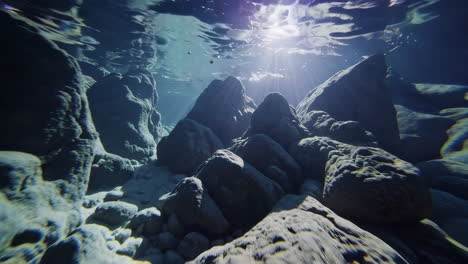 sunlight penetrates underwater rocks