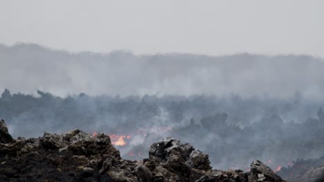 fiery molten lava flowing through a rocky landscape from grindavik volcano, sundhnúkur crater, iceland