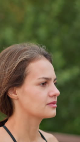 close-up view of lady running outdoors, blurred background with trees, woman jogging in park, enjoying outdoor exercise, focusing on fitness, healthy lifestyle, and vitality
