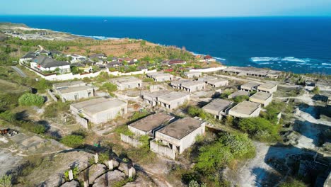 Aerial-during-sunshine-day-of-abandoned-resort-beach-at-Bali,-Indonesia