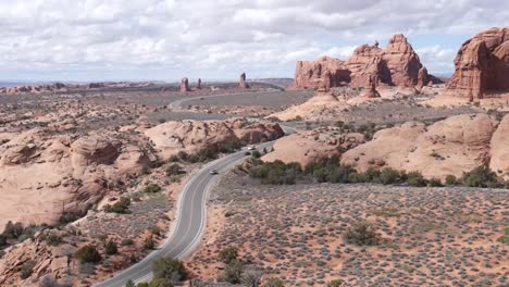 Cars-driving-down-a-long-desert-road