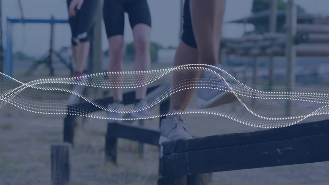People exercising on outdoor obstacle course with digital wave animation overlay