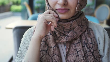 mujer con hijab en un café