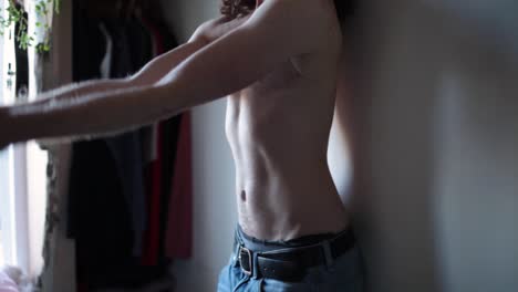 transgender man showing surgery scars on chest