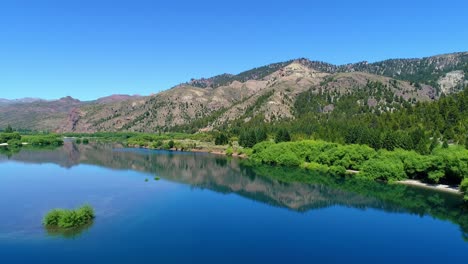 aerial view of a lake in northern patagonia with a deep blue and light blue sky-4