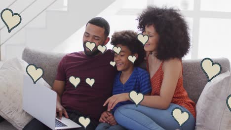 Animation-of-numbers-and-social-media-heart-icons-over-biracial-couple-with-son-using-laptop