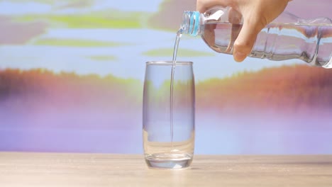 pouring water from bottle into glass