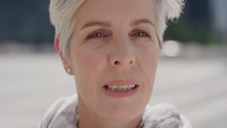 close up portrait beautiful senior woman turns head looking confident middle aged female enjoying sunny day in city slow motion aging beauty