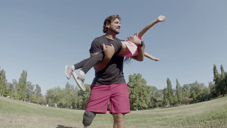 happy father with prosthetic leg circling daughter on hands