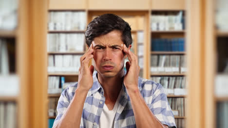 Caucasian-male-in-a-library-looking-at-the-camera,-confused