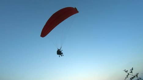 extreme paraglider flying against a clear blue sky. man with instructor flies with parachute. 4k, slow motion