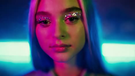 woman with glitter makeup in neon light