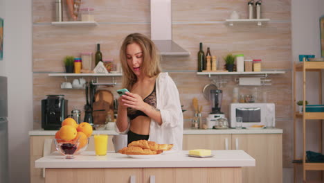 woman in lingerie dancing in kitchen