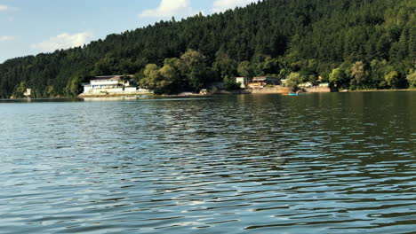 Reveal-shot-of-the-Pancharevo-lake,-Bulgaria,-starting-from-an-oar