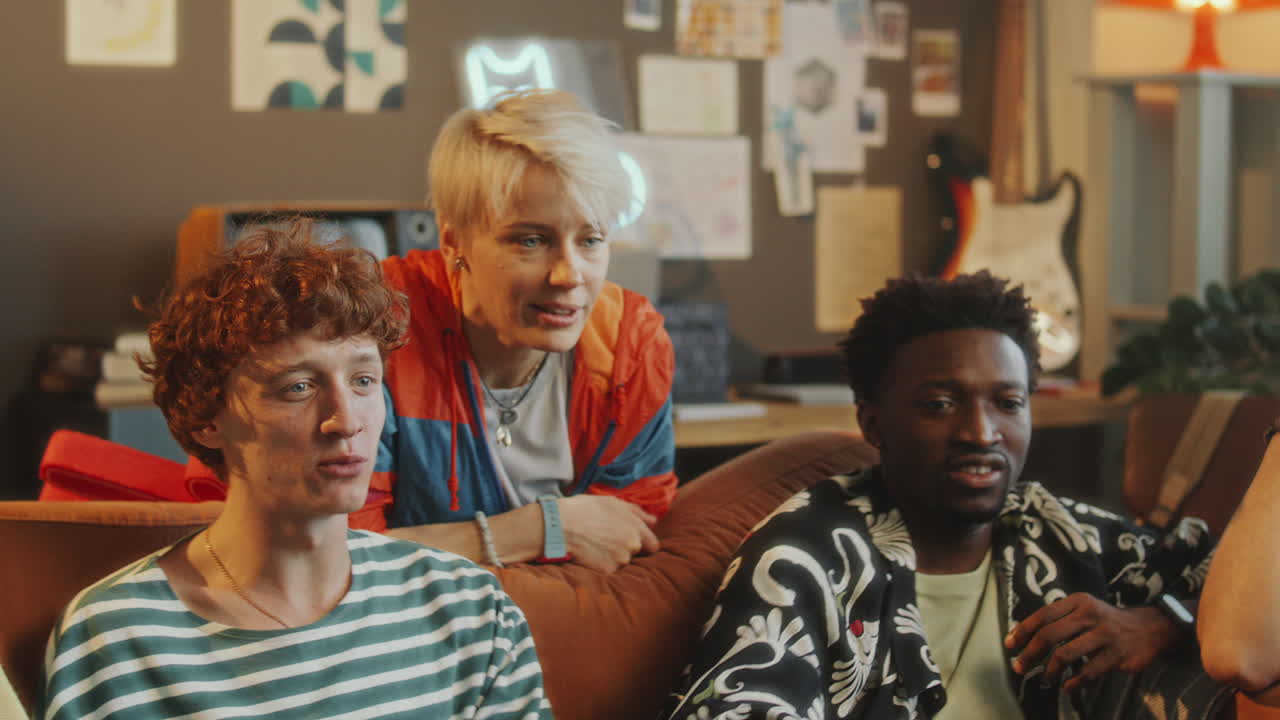 Excited Friends Watching Sports Match Together in Living Room