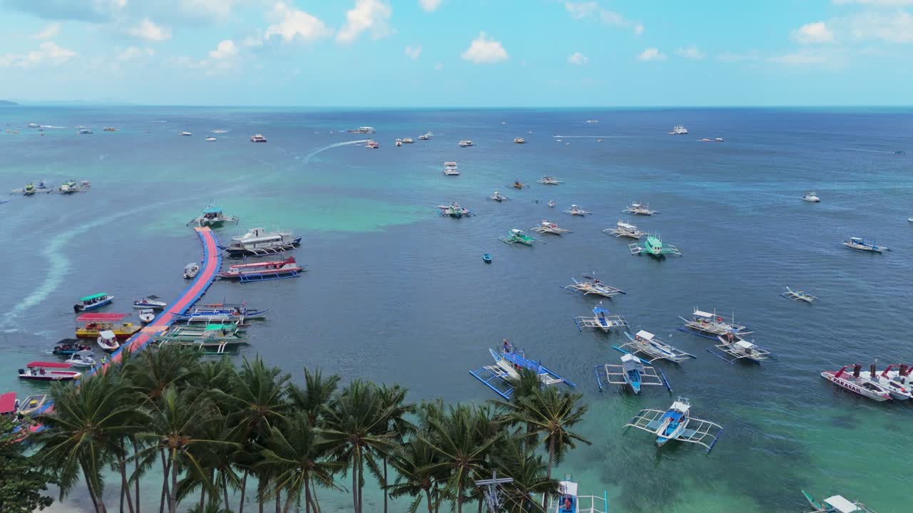 Aerial view of Boracay, Philippines showing floating pier, palm trees, and boats in turquoise waters. Perfect for travel, maritime, and tropical destination projects