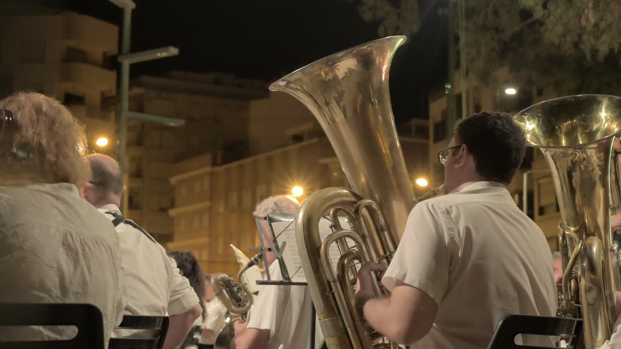 A brass band performing at night