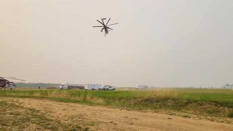 large heavy lift helicopters such as the sikorsky s-64 skycrane ready themselves for more firefighting in heavy smoke conditions