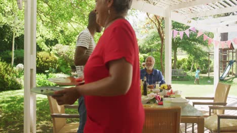 multi-generation african american family spending time in garden together