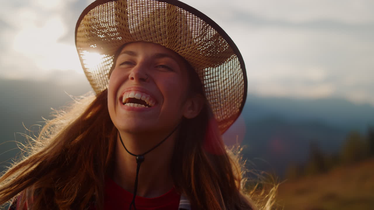 Smiling woman look sunset on mountains portrait. Playful model laugh on nature