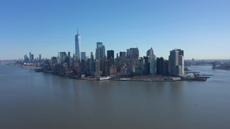 an aerial view over new york harbor on a sunny day with blue skies