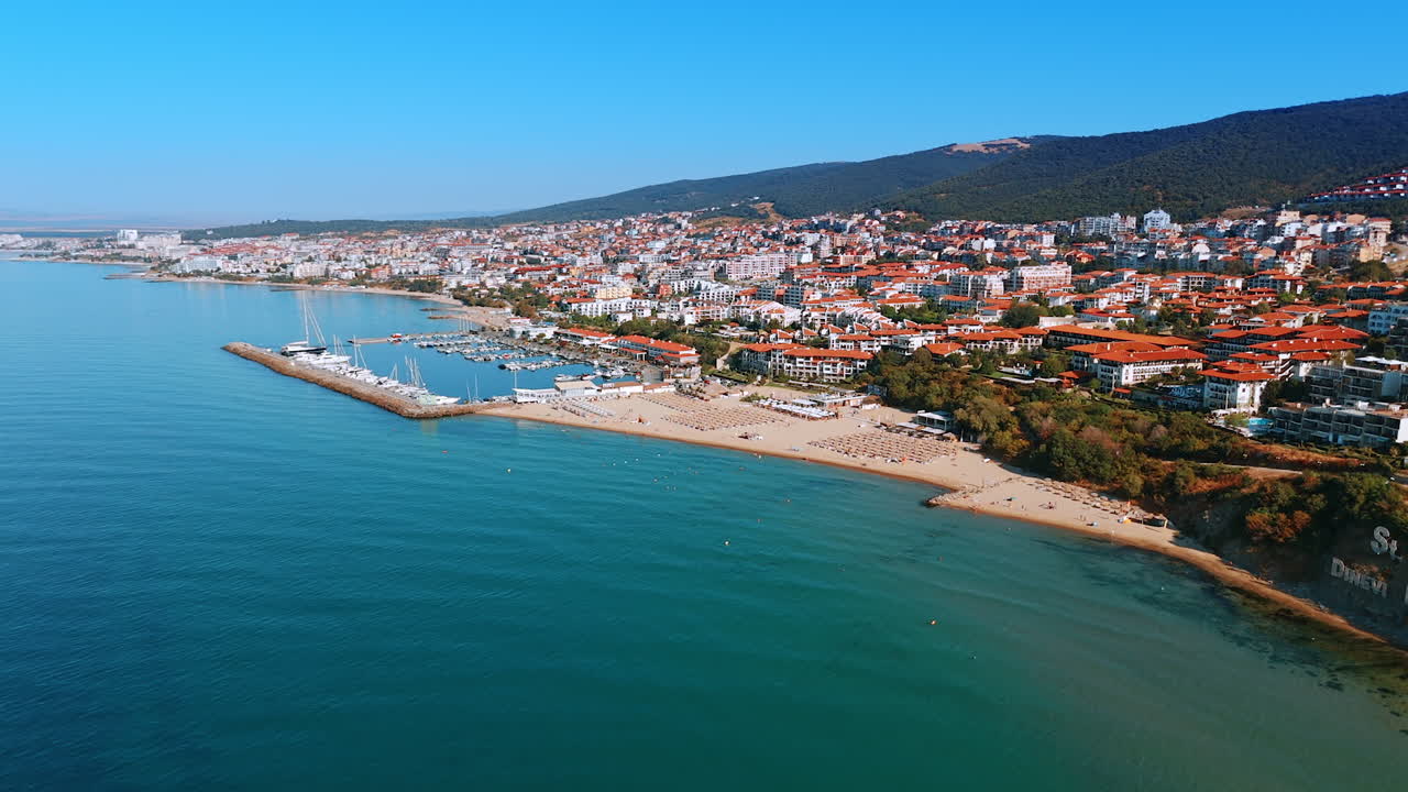 Aerial panorama of Sveti Vlas marina and coastline. Wide panoramic aerial shot of Sveti Vlas marina with yachts, beaches, and residential buildings along the Black Sea coast in Bulgaria