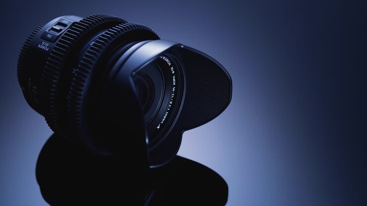 Film lens is artistically lit on a black background. Advanced optical technology.