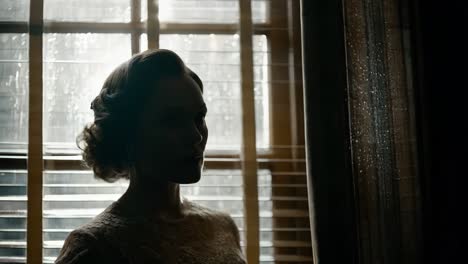 woman in silhouette by a window