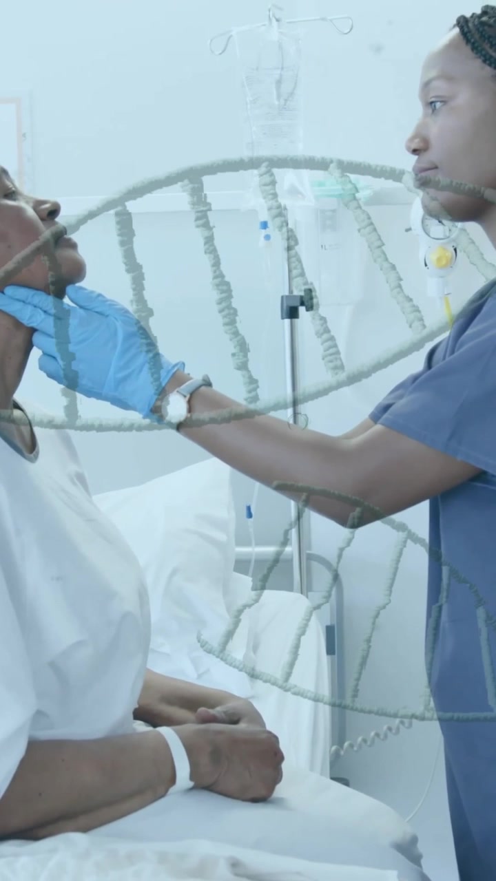 Animation of dna strands over african american female doctor giving senior patient check up