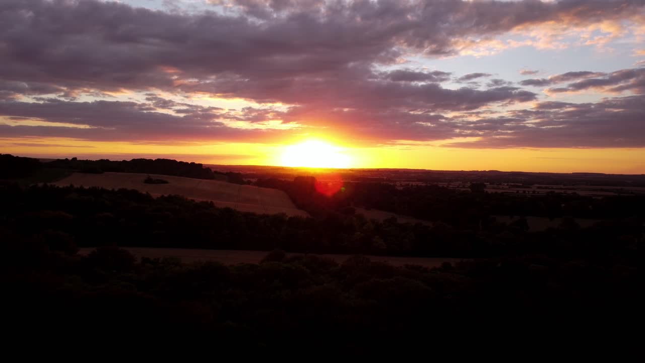 alejándose de una impresionante toma aérea del cielo del atardecer sobre los campos en hitchin, hertfordshire, inglaterra, reino unido