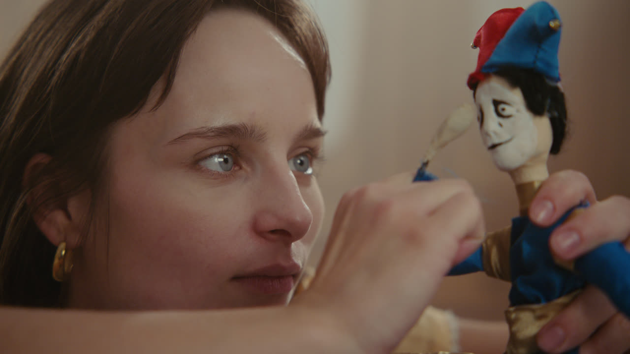 A girl playing with dolls in her room