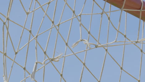 damage volleyball net on a sunny day at the beach