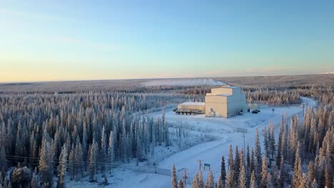 aerial, drone shot, panning over a road, towards the haarp alaska facility, on a cold and sunny, winter day, in gakona, usa