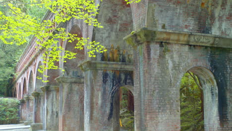 Brick-bridge-surrounded-by-beautiful-trees-in-the-background-in-Kyoto,-Japan-soft-lighting