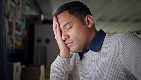 man tired working on computer with headache