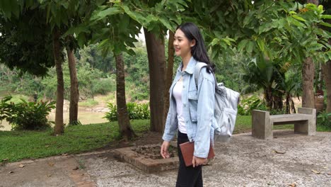 asian woman student walking to university, video in 4k